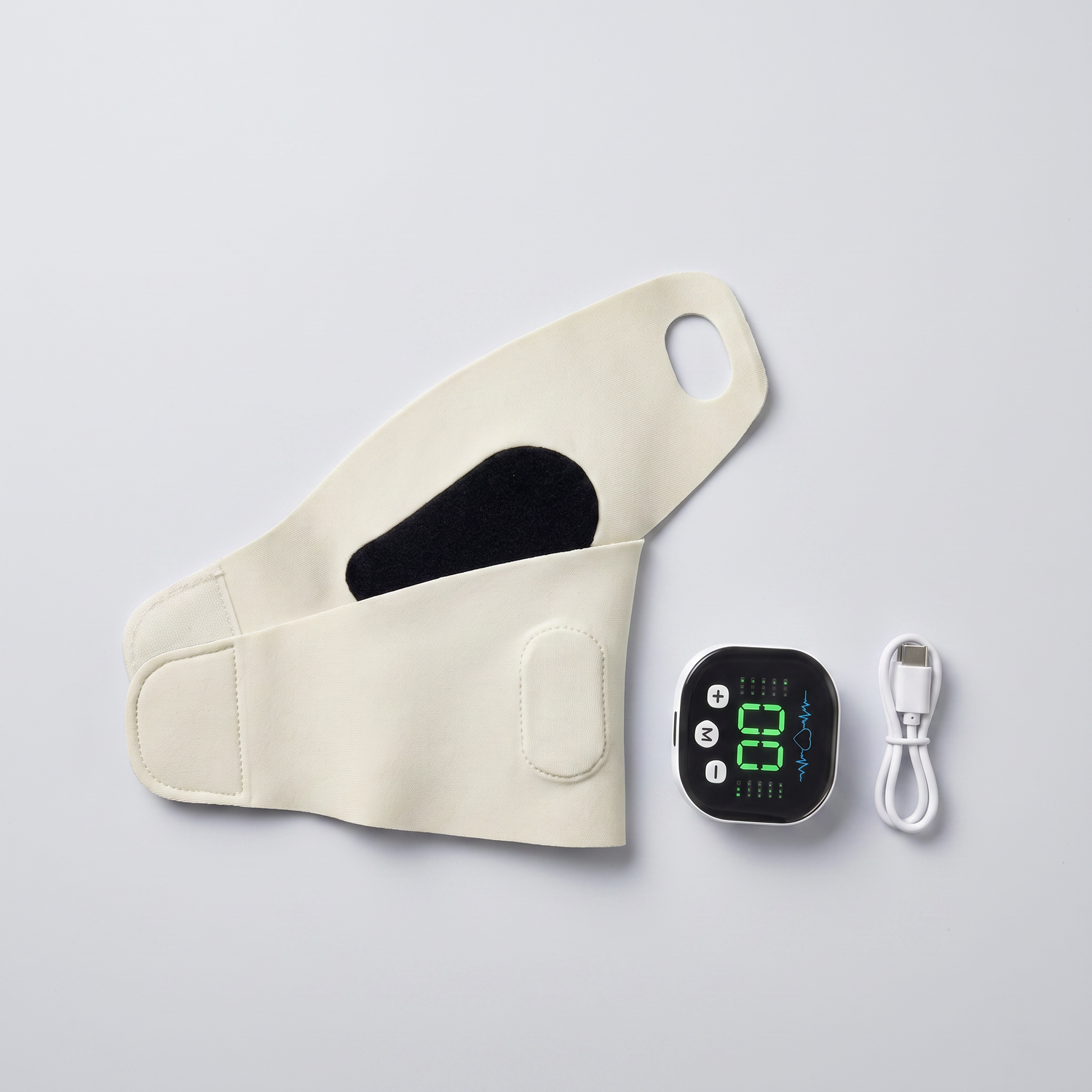 Masseur de poignet EMS à plat avec son câble de recharge USB-C