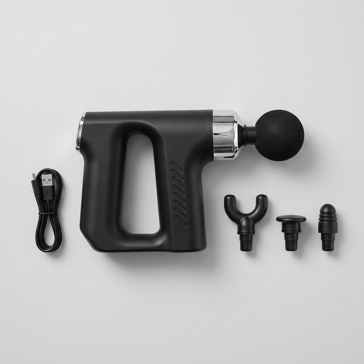Mini pistolet de massage à plat avec ses 4 têtes et son câble de recharge USB